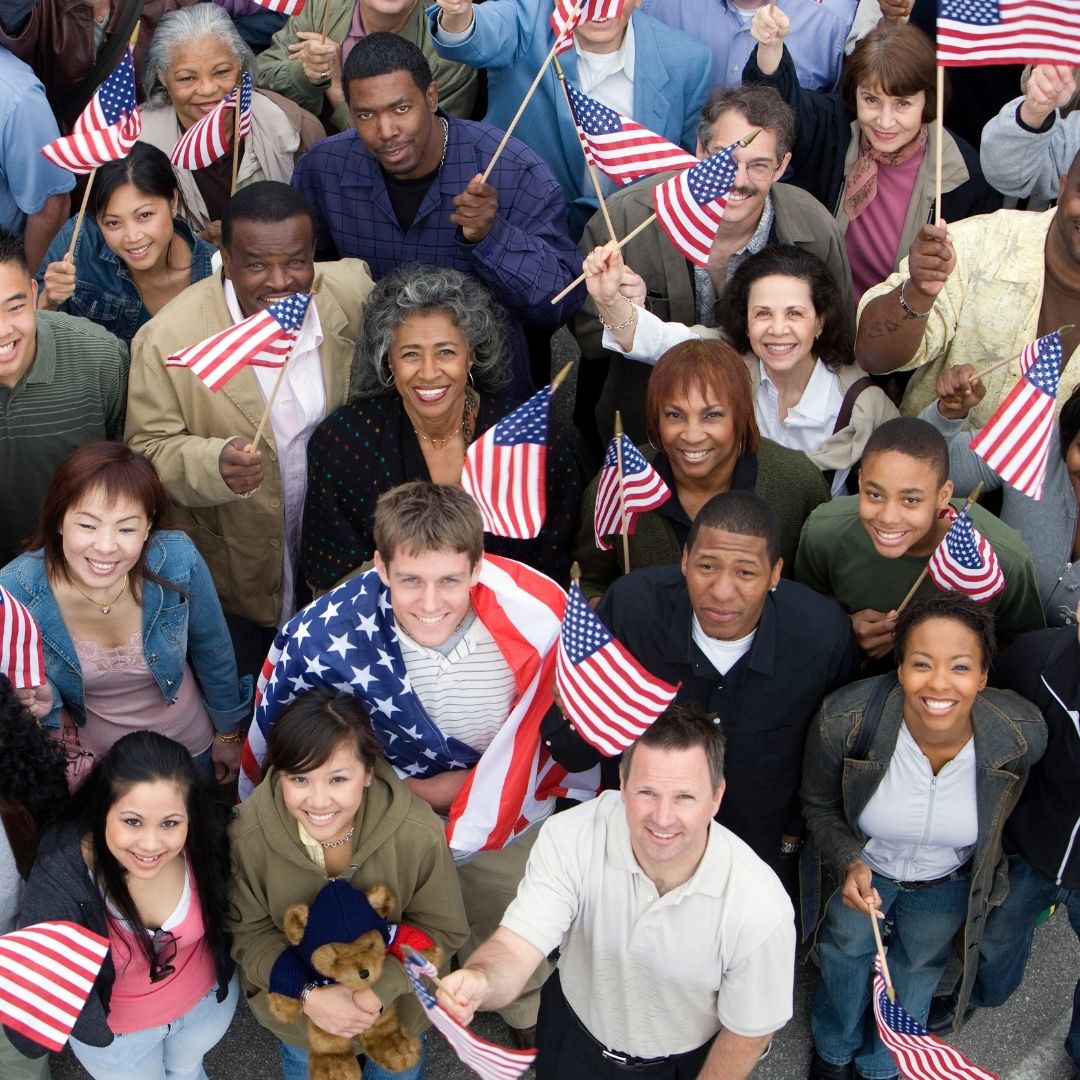 Group of smiling Americans holding small American flags