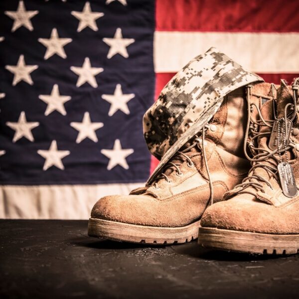 Army boots in front of flag
